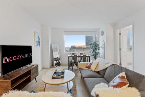 a living room with a couch and a tv at 2BR 3BA Condo On The Boardwalk CozySuites in Atlantic City