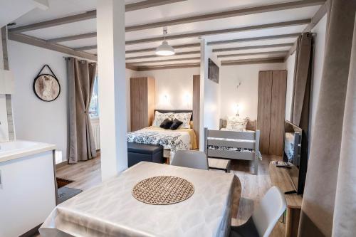 a room with a bed and a table and chairs at La Bayardine in Sarlat-la-Canéda