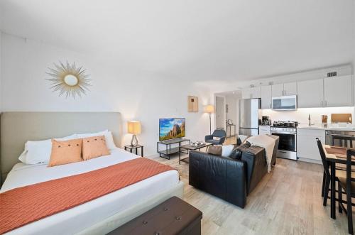 a bedroom with a bed and a living room at Sleep 4 Boardwalk Stylish Studio by CozySuites in Atlantic City