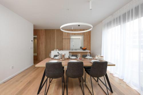 a kitchen and dining room with a table and chairs at FUX LUXURY Infinty-Pool Zadar in Zadar