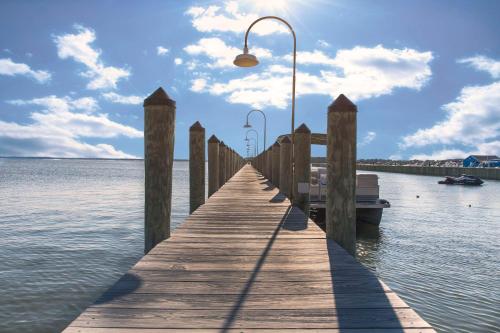 a wooden dock with a light on top of the water at Hyatt Place Dewey Beach in Dewey Beach
