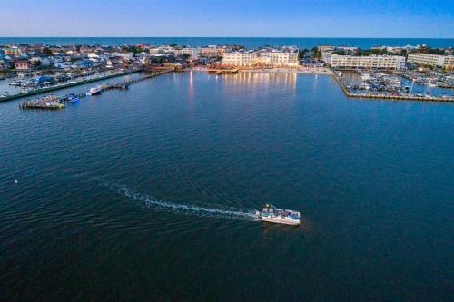 a boat in the water with a city in the background at Hyatt Place Dewey Beach in Dewey Beach