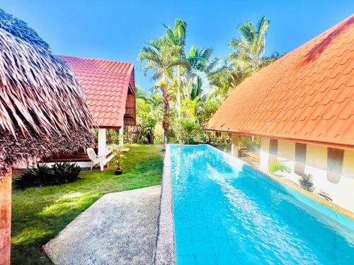 an image of a swimming pool next to a house at Boholala hostel in Panglao Island