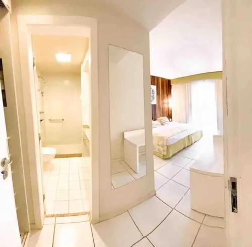 um quarto com uma casa de banho com uma cama e uma casa de banho em Búzios Beach Resort RJ em Búzios