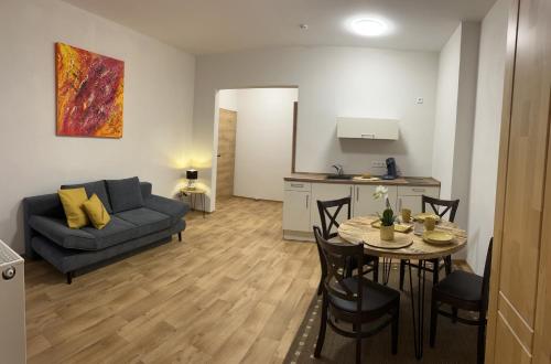 ANNA Gästehaus Zimmer في Pfreimd: غرفة معيشة مع أريكة وطاولة