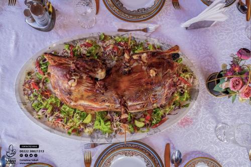 a plate of food with a turkey on a salad at Complexe Hôtelier Sabah in Nouakchott