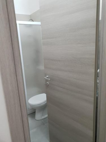 a bathroom with a toilet and a door at Holiday home Gala in Torre Squillace