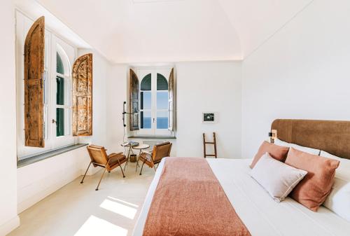 a bedroom with a bed and a table at Faro Punta Imperatore in Ischia