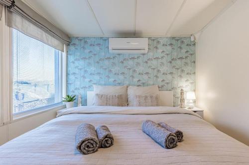 a bedroom with a large bed with two pillows on it at Očarujúci Houseboat na Dunaji in Bratislava