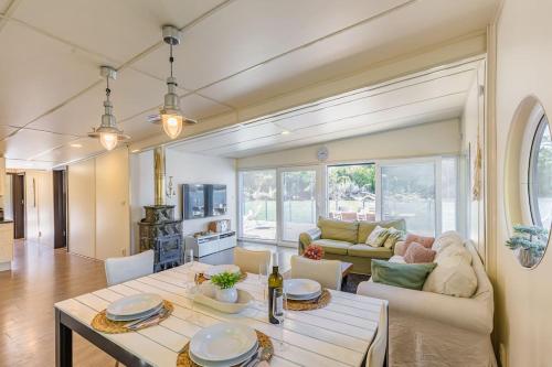 a living room with a table and a couch at Očarujúci Houseboat na Dunaji in Bratislava