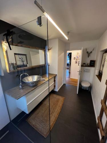a bathroom with a sink and a mirror at Flat Tom in Schwaighof