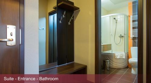 a bathroom with a toilet and a glass shower at INTER BUSINESS Bucharest in Bucharest