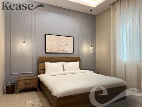 a bedroom with a large bed with white sheets at Kease Al-Mutamarat A-6 Timeless History XZ37 in Riyadh