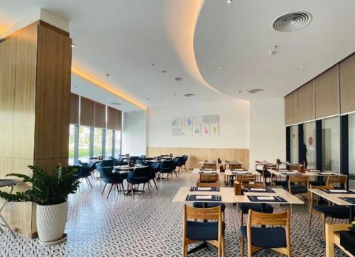 a dining room filled with tables and chairs at Seaside Skyway apartment Cam Ranh Nha Trang in Cam Lâm