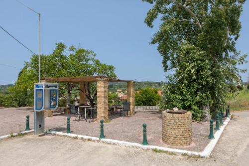 a gas station with a payphone in a park at sparrow apartment (Σπουργιτης) in Skoulikádhon