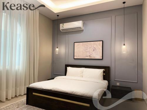 a bedroom with a bed and a air conditioner at Kease Al-Mutamarat A-3 Timeless History GX37 in Riyadh