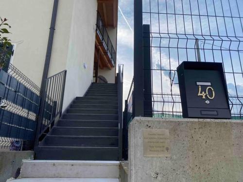 a set of stairs with a sign on a fence at Appartamento in Valpolicella (AquardensGardaVerona in Settimo