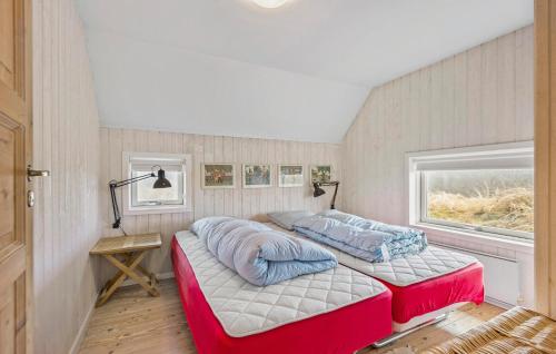 two beds in a room with a window at Beautiful Home In Fan With Wi-fi in Fanø