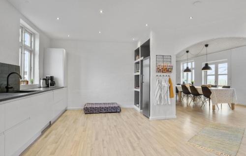 a kitchen and living room with a table and chairs at Nice Home In Roslev With Kitchen in Roslev