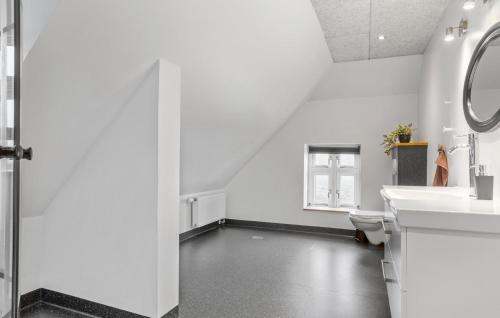 a white bathroom with a toilet and a sink at Nice Home In Roslev With Kitchen in Roslev