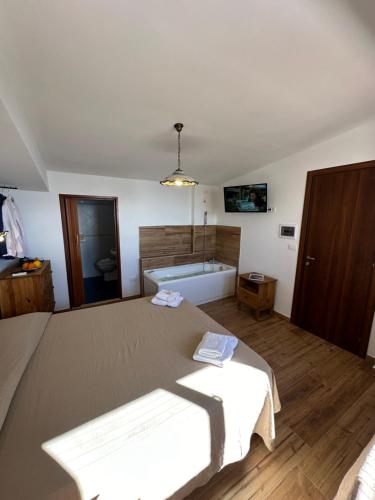 a bedroom with a large bed and a bath tub at B&B Villa sul Mare in Melito di Porto Salvo