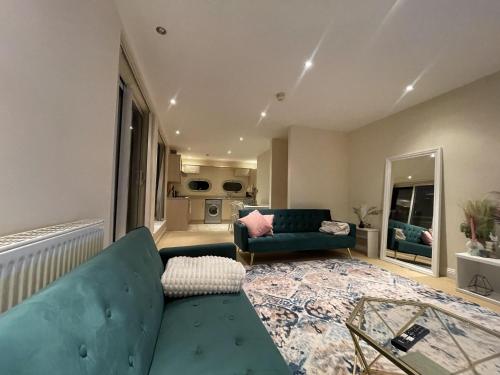 a living room with a couch and a table at Free parking near city centre & stadium sleeps 6-8 in Leicester