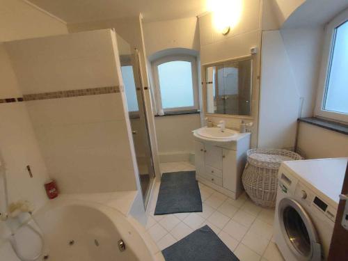 a bathroom with a tub and a toilet and a sink at Holiday home in Balatonboglar 48107 in Balatonboglár
