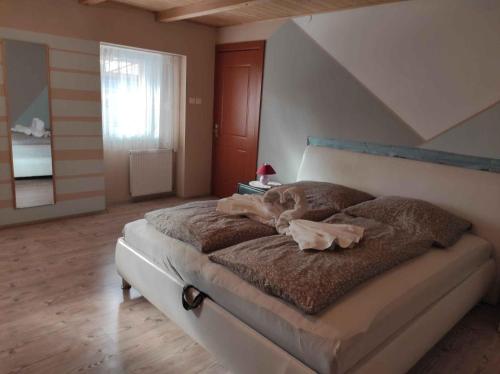 a bedroom with a large bed with brown blankets at Holiday home in Kereki - Balaton 48110 in Kereki