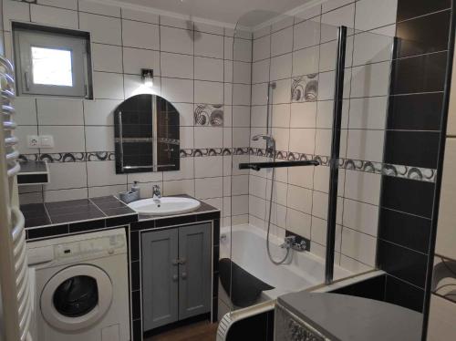 a bathroom with a sink and a washing machine at Holiday home in Kereki - Balaton 48110 in Kereki
