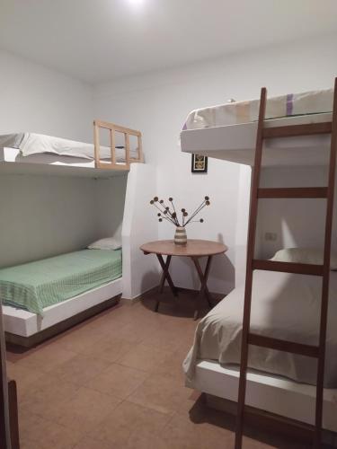 a room with two bunk beds and a table at Inka Dream in Cachora