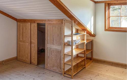 a room with a closet with wooden shelves at 4 Bedroom Cozy Home In Jnkping in Jönköping