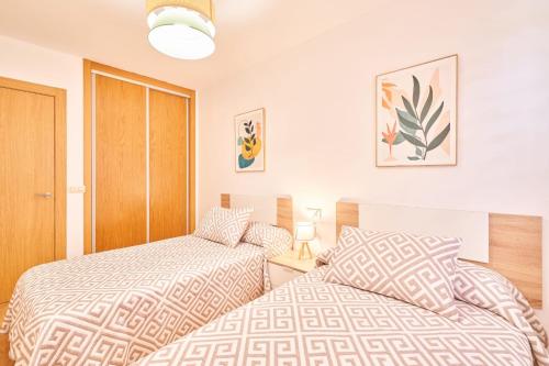 two beds sitting next to each other in a bedroom at El retiro de nirvana in Castellanos de Moriscos