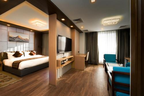 a hotel room with a bed and a television at Prudential Hotel Nepal in Kathmandu