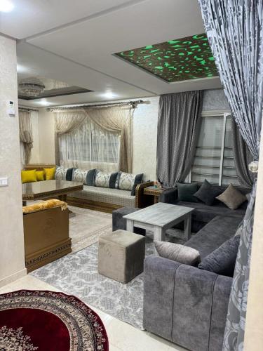 a living room with a couch and a table at appart luxe CORALIA 34 IL 7 in Oujda