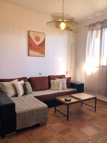 a living room with a couch and a coffee table at Flora Apartment - near the sea in Bar, Susanj
