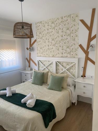 a bedroom with a bed with two towels on it at Isabella Center Boutique in Toledo