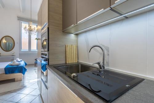 a kitchen with a sink and a counter top at Cozy Carisma Lodging - Central, New and Independent Studio Apartment in Sliema
