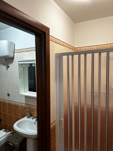 a bathroom with a sink and a toilet and a shower at Appartamenti Scilla Paese Albergo in Scilla