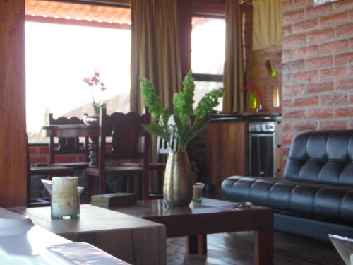 a living room with a couch and a table at Pumamaki EcoLodge Glamping in Quito