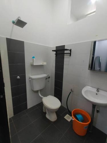 a bathroom with a toilet and a sink at A YIE HOMESTAY in Kuantan