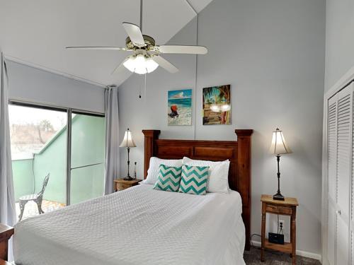 a bedroom with a bed and a ceiling fan at Cozy Coastal Repose in Padre Island