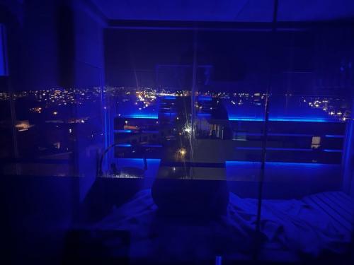 a room with a view of a city at night at Luxury penthouse with Kosice view in Košice