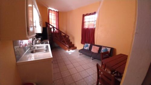 a small kitchen with a sink and a table at Southern Haven Beach House in Laborie