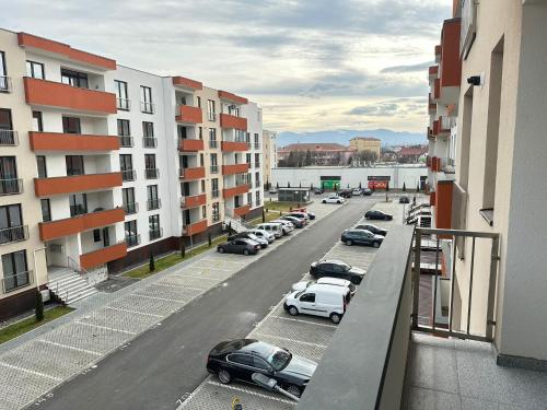a street with cars parked in a parking lot at Luxury Glam Apartments Sibiu near Station and Mall in Sibiu