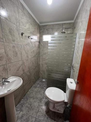 a bathroom with a toilet and a sink and a shower at Don machado in Puerto Iguazú
