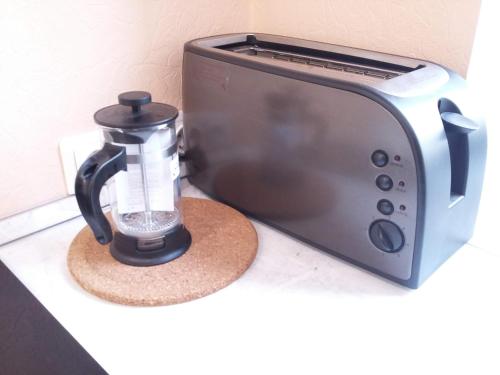 a coffee maker is sitting next to a toaster at Romantic Spirit in Riga in Rīga