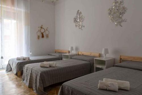 a room with three beds with towels on them at Apartment in Alassio - Ligurische Riviera 48200 in Alassio