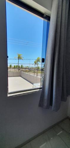 a window in a room with a view of a beach at Hotel Da Orla in Aracaju