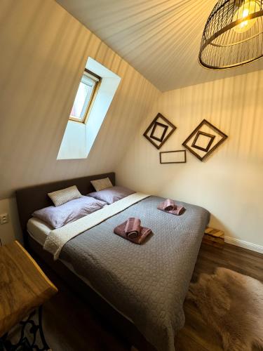 a bedroom with a bed with two towels on it at Opera apartments in Banská Štiavnica