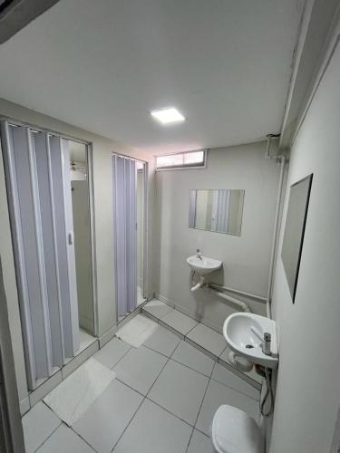 a bathroom with a toilet and a sink at Hostel São João in Araçariguama